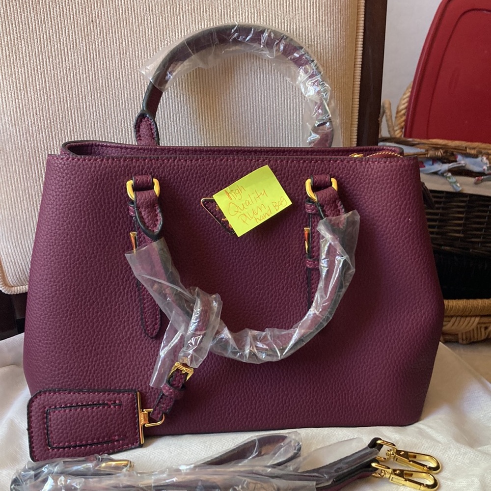 High quality plum colored hand bag NEW With dust bag